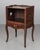 An early 20th century Louis XV Country French side table or nightstand made of solid walnut with an open niche and pierced...