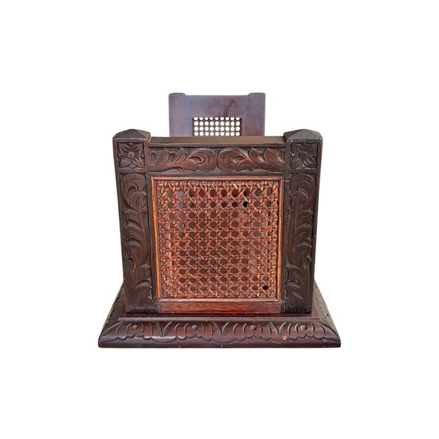 A fine early 20th century Jacobean Revival book slide of mahogany carved with foliate detail with original cane panels....