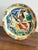 A striking and highly decorative mid-century glazed earthenware charger, likely French or Italian, dating to circa...