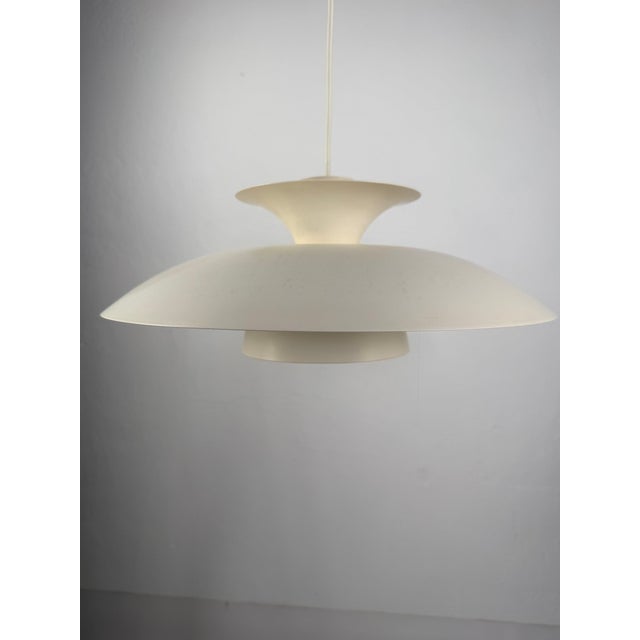 Scandinavian pendant lamp, 1960s–70s Denmark / Sweden A minimalist Scandinavian pendant lamp made of lacquered metal,...