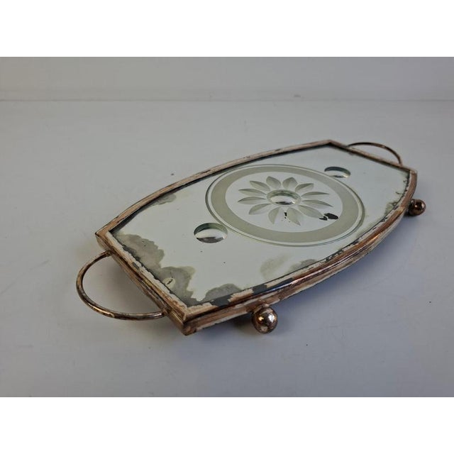 Elegant vintage mirrored glass serving tray with a beautifully etched floral motif, housed within a distinctive shaped...