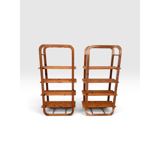 Striking pair of vintage tall bentwood étagères featuring beautifully rounded architectural frames and four tiers of open...