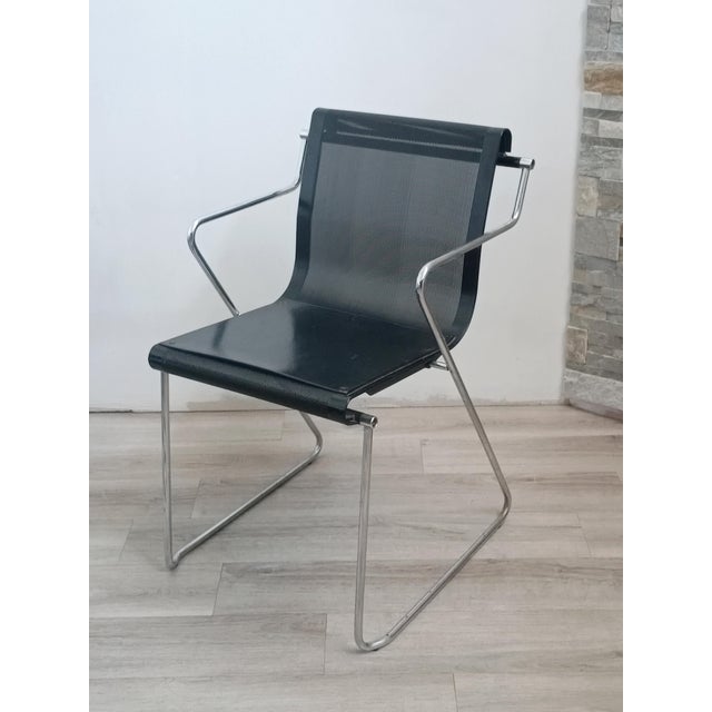 Beautiful Monopoli armchair by Pietro Arosio for Airon. Italy, 1970s. Black lacquered perforated metal frame. Chrome-...