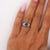 0.97 carat oval blue sapphire measuring 5.4 x 4.8mm is set in a platinum 900 ring featuring an ornate filigree floral...