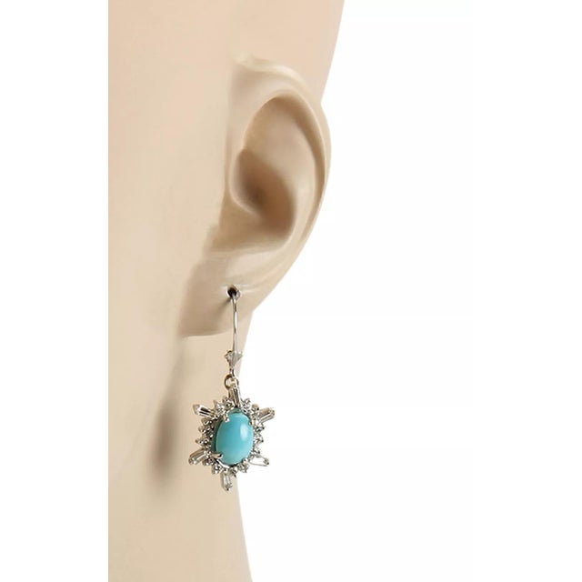 This pair of Estate earrings are crafted from 14k white gold with a polished finish. The hook top lever backs are in high...