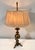 Bring substance to your dark academia study with this solid, brass cannonball form and tripod base lamp. The brass has a...