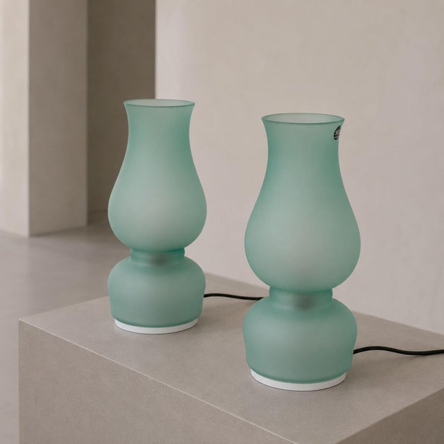 Elegant pair of Italian table lamps by Aureliano Toso, crafted in green Murano glass and dating from the late 1970s. Each...