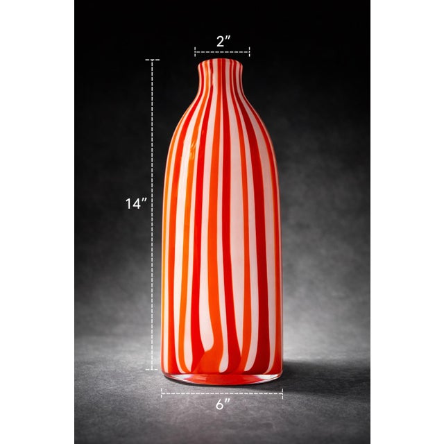 Bold Murano-style art glass vase with striking red, orange, and white vertical striping—heavy, sculptural, and designed to...