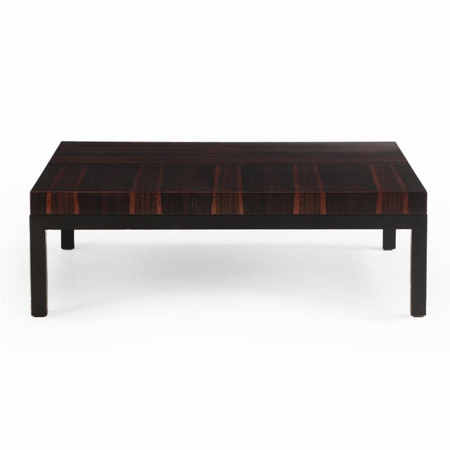 A beautiful and dramatic square rosewood top with pronounced wood grain, resting on four legs of ebonized oak. The Boke...