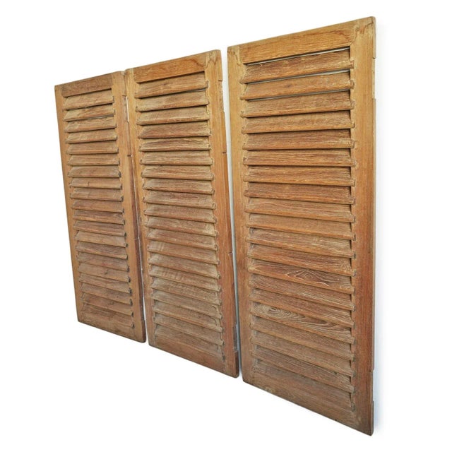Vintage set of three of teak wood screen doors from Sri Lanka. Sold as a set. Each panel measures 18.5" wide.