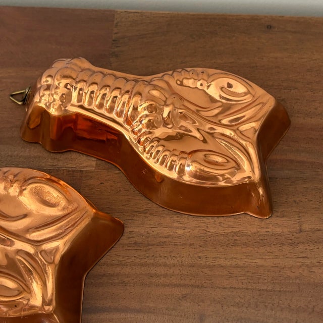 Charming pair of 1970s copper lobster jello mold wall hangings with hooks. Most items found at Pub & Oasis are vintage and...