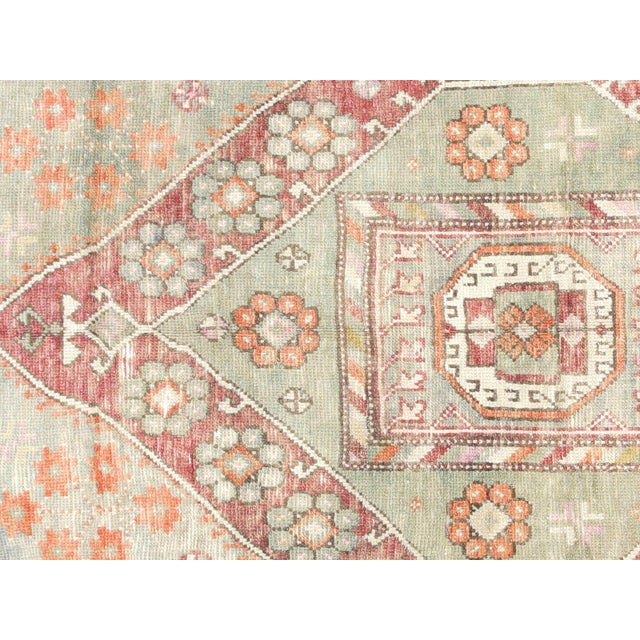 This beautiful vintage Turkish Oushak Rug is hand-knotted with 100% wool on a wool foundation to provide a soft, warm...