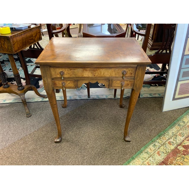 19th century Queen Anne style table with three drawers. Burlwood walnut, herringbone inlay edge, slipper feet.