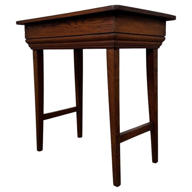 A beautifully crafted early 20th-century English Edwardian side table, finely constructed in oak and distinguished by its...