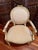 1940s–1950s large Louis XVI Revival armchair featuring an oval upholstered back topped with a carved ribbon-bow crest. The...