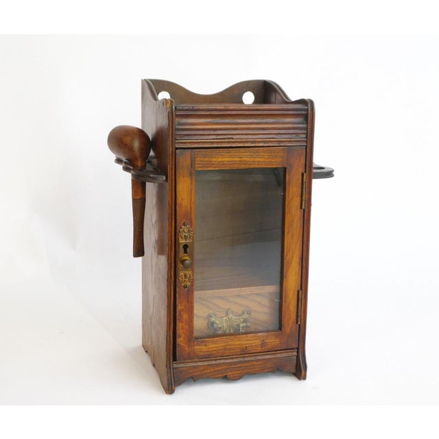 Wooden English antique smokers cabinet with amazing details all over and very well made. It has two racks on each side for...