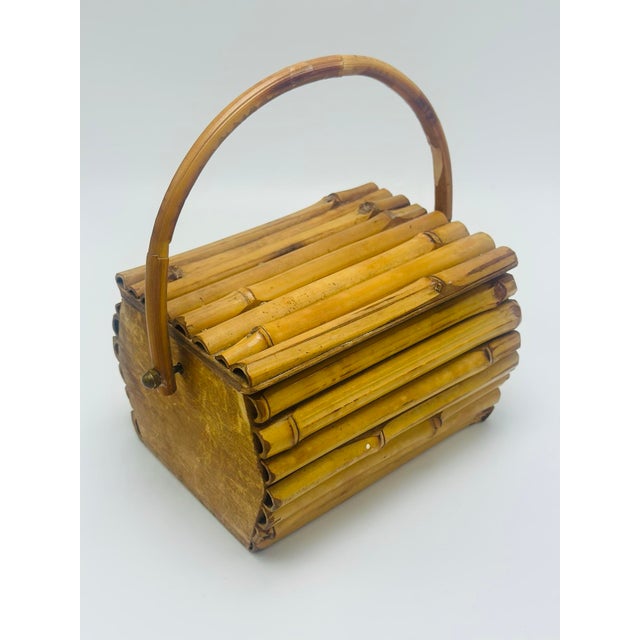 This charming vintage bamboo and rattan lidded basket showcases the natural beauty of handcrafted tropical materials....