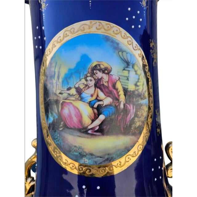This stunning porcelain vase is brilliantly decorated with a deep cobalt base colour, complemented with beautiful images...