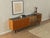 Classic sideboard from the 1960s. Body in walnut veneer with two cabinet doors, two glass sliding doors, a shelf, a glass...