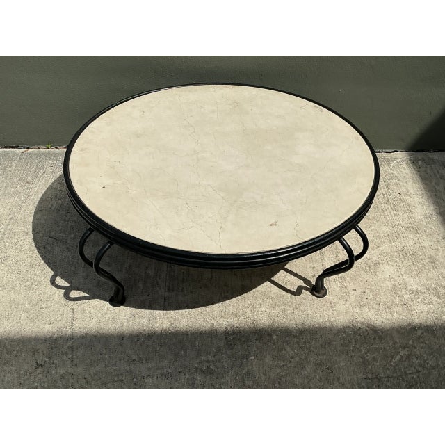 Showcasing understated mid-century elegance, this vintage round coffee table features an inset cast stone top with...