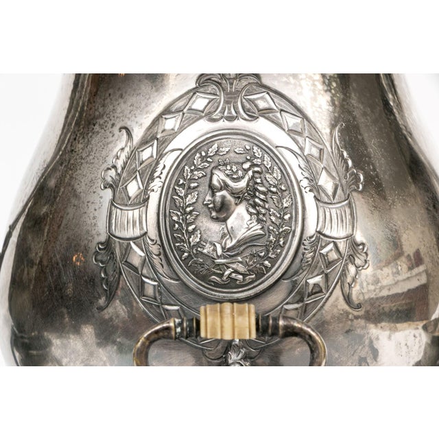An exceptional Victorian-era Meriden Britannia Co. silverplate garniture set featuring a monumental samovar or tea urn...