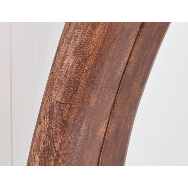 At six feet in diameter, this large scale mirror brings the drama. The light walnut frame brings warmth to the plain mirror.