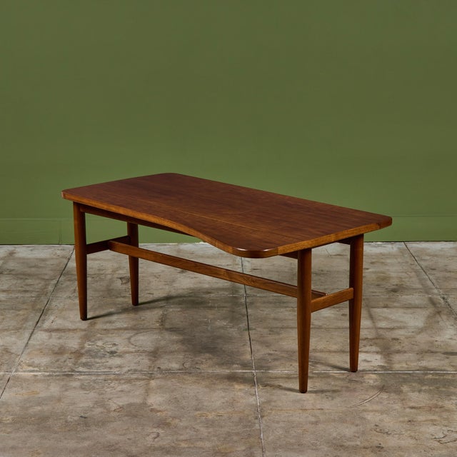 Finn Juhl walnut drop leaf table for Baker Furniture, c.1950s, USA. The asymmetrical table is a perfect height for an...
