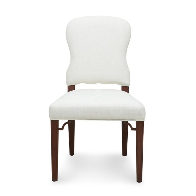 This comfortable, upholstered saddle seat dining chair comes ready-to-ship in two different finish/upholstery...