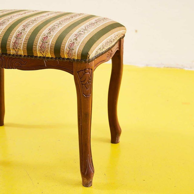 Discover the timeless beauty of this vintage stool, featuring a refined green and beige striped fabric upholstery with...