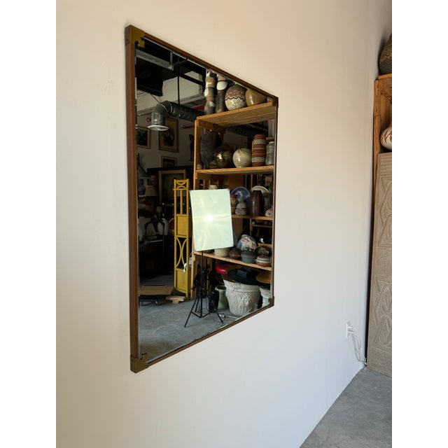 A stylish Vintage Chinese - Asian style wood and accent brass decorative wall mirror. Dramatic performance with full-...