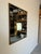 A stylish Vintage Chinese - Asian style wood and accent brass decorative wall mirror. Dramatic performance with full-...