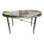 Asian influenced faux bamboo brass base coffee table with original glass in-set top, executed by legendary cabinetmaker of...