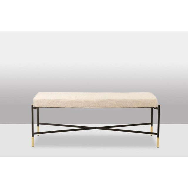 Pair of benches. White fabric seat. Lacquered and gold metal base. Work realised in the 2000s. This piece is designed in...