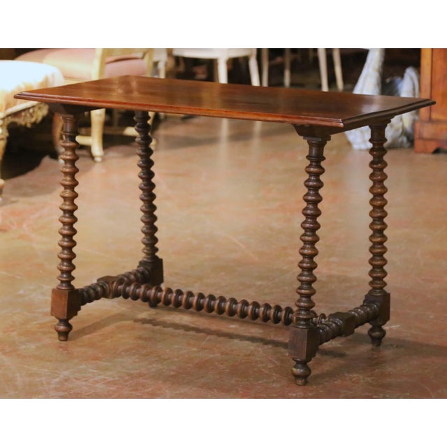 Distinguished by its unusually slender proportions and rhythmic turned construction, this antique Spanish console table...