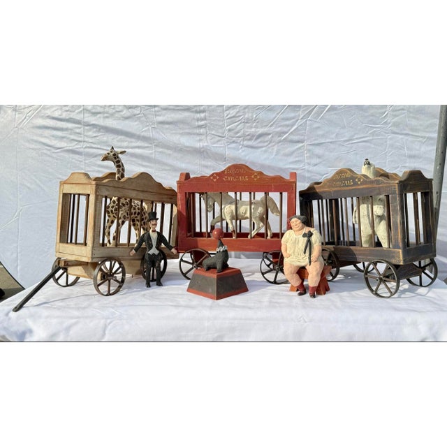 Step right up — a complete vintage folk-art carnival: thirteen hand-painted figures with four wooden cage wagons, ready to...