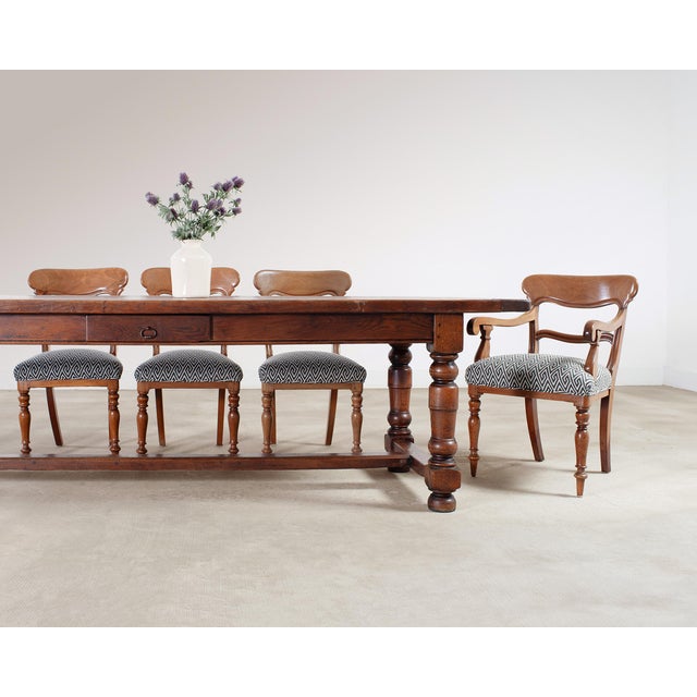 A handsome late 19th century French country farmhouse dining table constructed in solid oak measuring 9 feet long. The 2"...