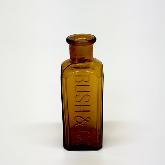 Amber glass bottles, group of 5. A retro curated group of amber brown mid-century apothecary bottles in a variety of...