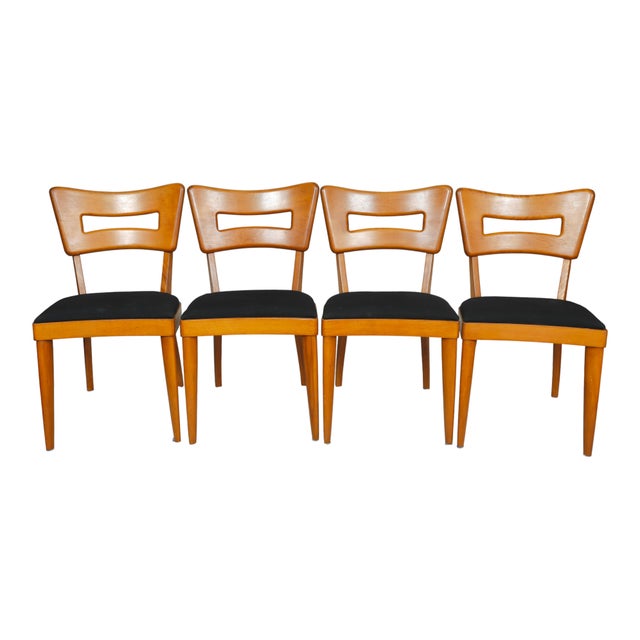 A set of four birchwood M154 "Dog Biscuit" dining chairs designed by Heywood Wakefield, circa 1950. One of their most...
