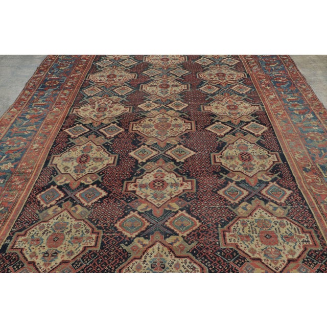 Hand-knotted in wool, this 8x15 antique Bakhtiari rug, circa 1900-1920, is a distinguished example of the region’s iconic...