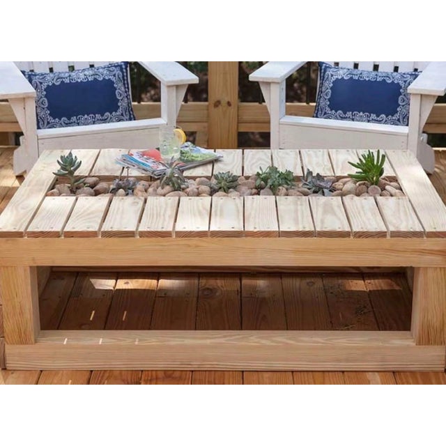 Handcrafted outdoor coffee table featuring a built-in center planter designed for decorative rocks, greenery, succulents,...