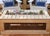 Handcrafted outdoor coffee table featuring a built-in center planter designed for decorative rocks, greenery, succulents,...