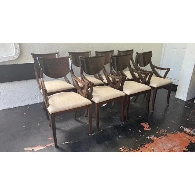 A refined suite of eight Pietro Costantini dining chairs, crafted in Italy and finished in a rich, high-gloss walnut...