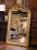Standing nearly five feet tall, this antique mirror displays the graceful curves and elaborate ornament associated with...