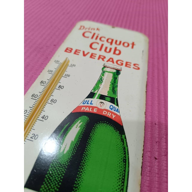 Elevate your space with a timeless piece of Americana. This exquisite Vintage-Style Clicquot Club Ginger Ale Metal...
