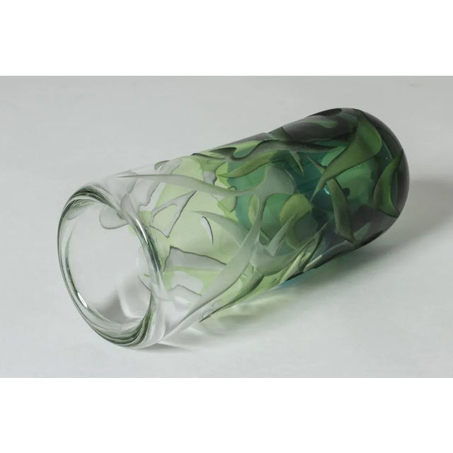 Striking, unique glass vase by Vicke Lindstrand, made with overlay technique. Layers of green and clear glass with an...