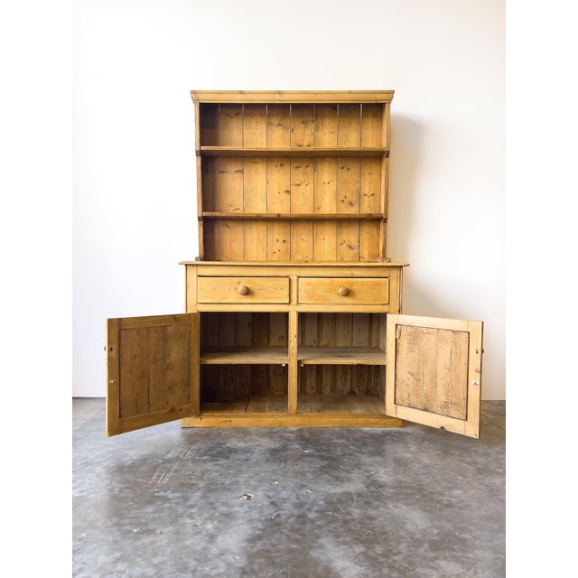 This antique 19th-century pine dresser is charming and compact in size with a classic design. It features an open two-tier...