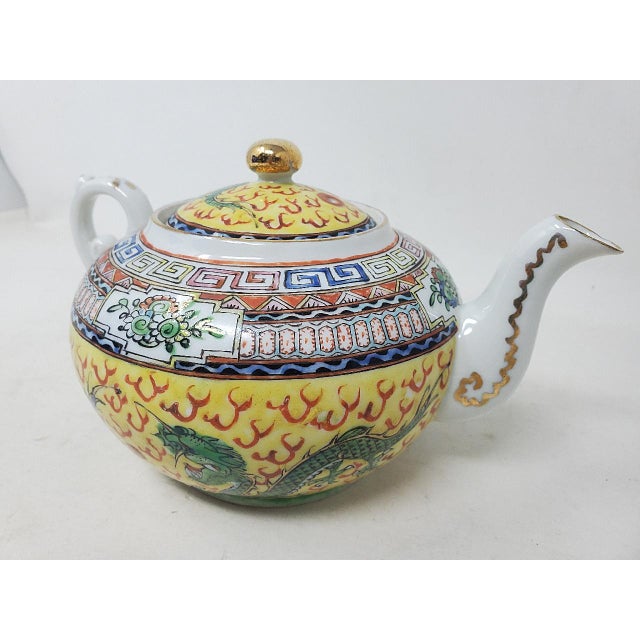 Here is a vintage famille rose teapot made in Hong Kong, China. The intricate details of this piece include dragons and...