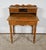 Solid blonde bureau with a cut belt with a central drawer with an original key and lock. This piece of furniture rests on...
