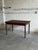 Beautiful vintage Danish modern dining table crafted in teak, featuring elegant minimalist lines, tapered round legs, and...