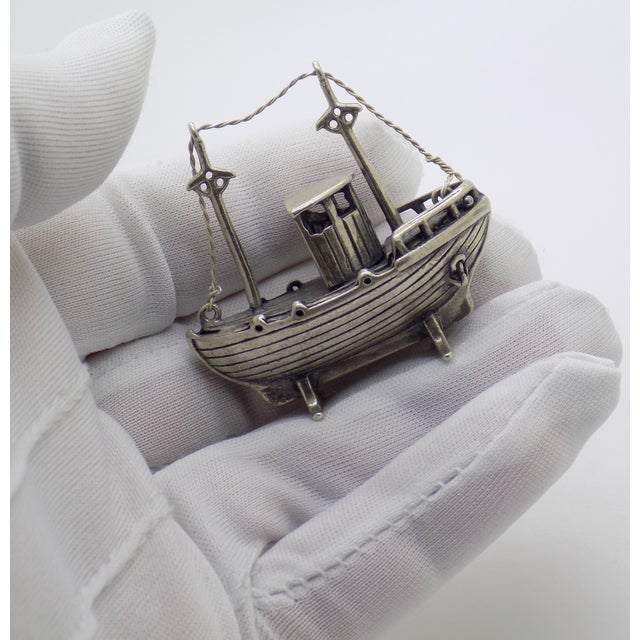 Detailed vintage sculpture depicting a fisherman on a boat, handmade in Italy between the 1970s and 1980s in genuine...